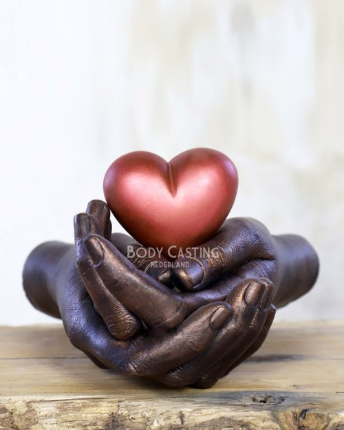 Bodycasting sculptuur met hart liefdevol gedragen door handen